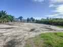 Wide angle shot of vacant lot showing neighborhood in the background under blue skies at 5105 W Longfellow Ave, Tampa, FL 33629