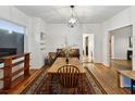 Bright dining room with hardwood floors, a rug, and a view into other rooms at 5604 N Cherokee Ave, Tampa, FL 33604