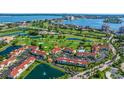 Expansive aerial view highlights the golf course and lake, complemented by well-maintained community buildings and lush landscaping at 6059 Bahia Del Mar Blvd # 134, St Petersburg, FL 33715