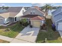 An aerial view of a home with manicured lawn and two-car garage, situated in a quiet neighborhood at 10610 Lakeside Vista Dr, Riverview, FL 33569