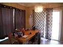 Dining room featuring brown curtains, a hanging chandelier, and a sliding glass door at 11019 Connacht Way, Tampa, FL 33610