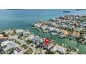 Stunning aerial view of waterfront home with boat dock in a desirable coastal community at 116 9Th E St, Tierra Verde, FL 33715