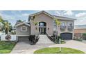 Charming two-story home with grand staircase leading to an elegant double door entrance at 116 9Th E St, Tierra Verde, FL 33715