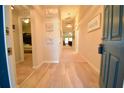 Inviting home entryway with beach themed decorations and neutral paint, featuring a view into other rooms at 12820 Bent Twig Dr, Riverview, FL 33579