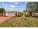 Charming single-story home featuring a well-maintained lawn and inviting curb appeal on a sunny day at 1629 Dartmouth Dr, Holiday, FL 34691