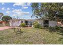Charming single-story home with a well-maintained lawn and inviting curb appeal on a sunny day at 1629 Dartmouth Dr, Holiday, FL 34691