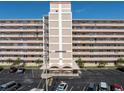 Front view of the Shorecrest Condominiums with a well-maintained facade, reserved parking, and a manicured landscape at 1847 Shore S Dr # 215, South Pasadena, FL 33707