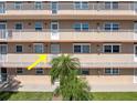 A nice facade with a small palm tree that provides shade near the entrance of the home at 1847 Shore S Dr # 215, South Pasadena, FL 33707