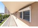 Long hallway leading to a unit with views of the beach area and multiple windows to let in the natural light at 1847 Shore S Dr # 215, South Pasadena, FL 33707