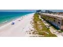 Aerial of beautiful beach and condo with ocean access and walking path at 3100 Gulf Blvd # 134, Belleair Beach, FL 33786