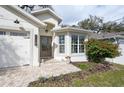 Charming single-story home featuring a landscaped front yard, brick pathway, and double-door entryway at 3405 W Cherry St, Tampa, FL 33607