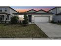 Charming single-story home featuring a two-car garage and well-maintained front yard with manicured landscaping at 4275 Big Sky Dr, Spring Hill, FL 34604