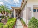 Welcoming front entrance, framed by lush landscaping, a well-kept walkway, and a tiled roof at 4372 Water Oak Way, Palm Harbor, FL 34685