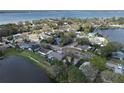 Stunning aerial view of a neighborhood with lush trees and a beautiful lake in the background at 641 Bay Lake Trl, Oldsmar, FL 34677