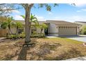 Well-maintained single-Gathering home with a spacious two-car garage and vibrant landscaping in front yard at 641 Bay Lake Trl, Oldsmar, FL 34677