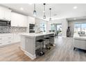 Open concept kitchen featuring quartz counters, stainless steel appliances, a center island, and breakfast bar at 7276 Notched Pine Bnd, Wesley Chapel, FL 33545