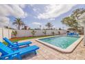 Refreshing pool area complete with lounge chairs, lush landscaping, and privacy fence at 7998 Causeway N Blvd, St Petersburg, FL 33707