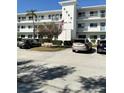 Condo building featuring modern architecture, well-maintained landscaping, and convenient parking at 8080 112Th St # 206, Seminole, FL 33772