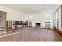 Spacious living room with fireplace, natural light, and hardwood floors, ready for renovation at 864 15Th Ne Ave, St Petersburg, FL 33704