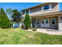 Inviting home exterior features a manicured lawn, attractive landscaping, and a cozy front porch with double doors at 1375 Corner Oaks Dr, Brandon, FL 33510