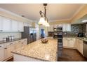 Spacious kitchen features an island, granite countertops, stainless steel appliances, and ample cabinet space at 1375 Corner Oaks Dr, Brandon, FL 33510