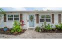 Charming home featuring a landscaped front yard and a light blue front door at 1415 54Th N Ave, St Petersburg, FL 33703