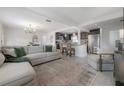Open concept living area with modern decor, lots of light and a view to the kitchen at 1415 54Th N Ave, St Petersburg, FL 33703