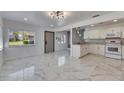 Bright and spacious kitchen featuring white cabinets, granite countertops, and modern appliances at 1828 Bough Ave # 3, Clearwater, FL 33760