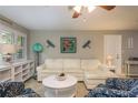 Bright living room showcasing a white couch, cheerful decor and abundant natural light at 2005 Harvard Ave, Dunedin, FL 34698