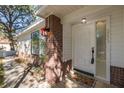 Charming front door with brick pillars, holiday decor, and manicured landscaping, creating an inviting entrance at 2233 Springwood W Cir, Clearwater, FL 33763