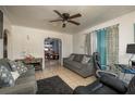 Inviting living room featuring tile floors, ceiling fan, two sofas, and access to other rooms at 2501 Auburn S St, St Petersburg, FL 33712