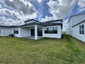A spacious backyard with a well-maintained lawn and a covered patio, ideal for outdoor activities at 32347 Wetland Bird Vw, San Antonio, FL 33576