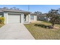 Charming home with well-maintained lawn, one-car garage, and neutral color scheme at 37850 Prairie Rose Loop, Zephyrhills, FL 33542