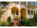Inviting entryway with red brick steps leading to an arched doorway and a light blue door at 6030 Printery St # 107, Tampa, FL 33616