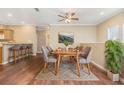 Cozy dining area with seating for six, modern decor, and hardwood floors at 7631 Sailwinds Pass, Port Richey, FL 34668