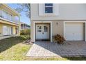 Inviting entrance featuring double doors, a covered porch, and lush landscaping, offering excellent curb appeal at 7631 Sailwinds Pass, Port Richey, FL 34668