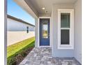 Stylish front door with decorative glass, sidelight, and transom window for a grand entrance at 9412 Coastline Way, Parrish, FL 34219