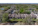 Aerial view featuring condo building, landscaping, and a view overlooking a canal in the rear at 13385 Arbor Pointe Cir # 203, Tampa, FL 33617