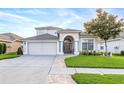 Beautiful two-story home boasts a well-kept lawn, charming accents and inviting two-car garage at 16313 Dinsdale Dr, Spring Hill, FL 34610