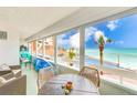 This enclosed balcony overlooks the beach and has a seating area at 17940 Gulf Blvd # 2B, Redington Shores, FL 33708