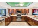 Updated kitchen boasts stainless appliances, granite countertops, and custom wood cabinets at 17940 Gulf Blvd # 2B, Redington Shores, FL 33708