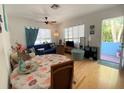 Bright living room featuring hardwood floors, ceiling fan, and decor with a table and chairs in the foreground at 1800 Pass A Grille Way # 5, St Pete Beach, FL 33706