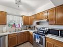 Kitchen featuring light-colored countertops, stainless steel appliances, and a window with natural light at 2009 Hammock Pine Blvd # 2009, Clearwater, FL 33761