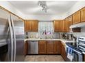 Traditional kitchen with stainless steel appliances, oak cabinets, and tile floors at 2009 Hammock Pine Blvd # 2009, Clearwater, FL 33761