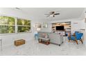 Bright living room featuring marble floors, modern decor, and large windows with natural light at 2037 Church Creek Pt, Largo, FL 33774