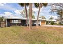Beautiful home with a well-kept lawn, a large tree, and an attached garage at 2080 Attache Ct, Clearwater, FL 33764