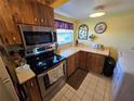 Efficient kitchen with stainless steel appliances, white countertops, and modern laundry machines at 24862 Us Highway 19 N # 2906, Clearwater, FL 33763