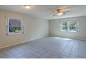 Bright and airy living room featuring large windows, neutral paint, and tile flooring for easy maintenance at 2847 Rampart Cir, Clearwater, FL 33761