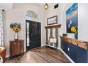 Inviting foyer with hardwood flooring, decorative accents, and a statement front door at 31123 Stone Arch Ave, Wesley Chapel, FL 33545
