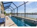 Relaxing screened pool with beautiful water feature overlooking the lake at 33899 Astoria Cir, Wesley Chapel, FL 33545
